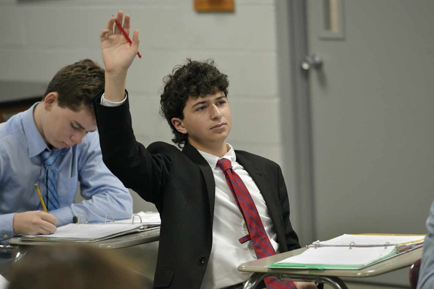 MUS student raising his hand in class.
