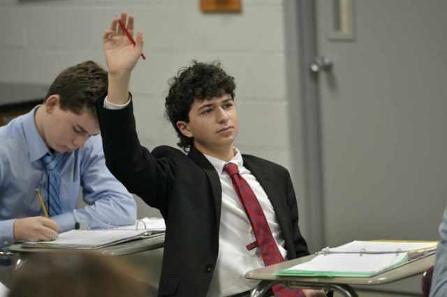 MUS student raising his hand in class.