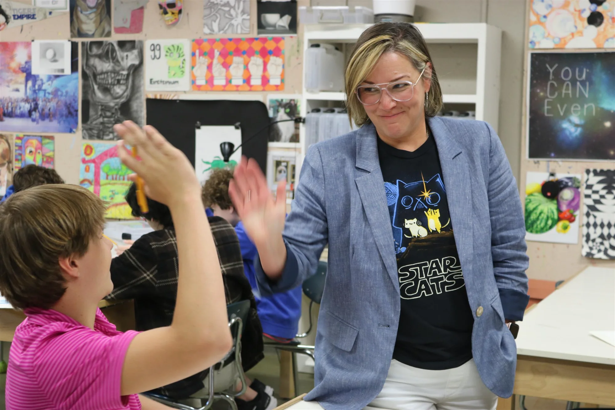 Instructor giving a student a high five.