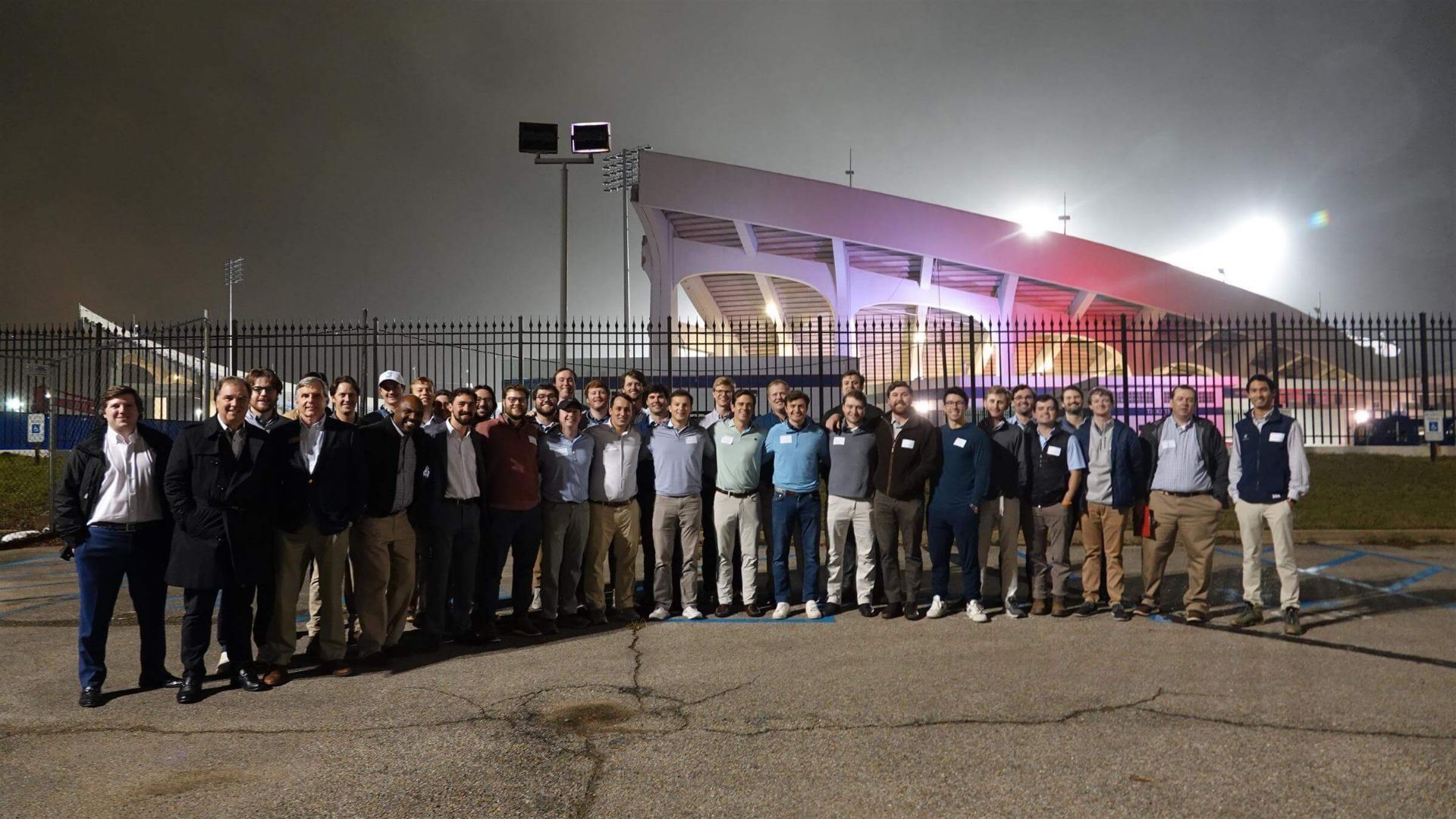 group of men posing in front of Simmons Bank Stadium