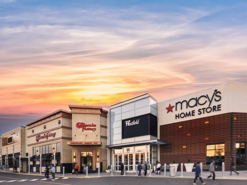 Photo of exterior of Westfield Montgomery mall with Macy's and Cheesecake Factory signs.