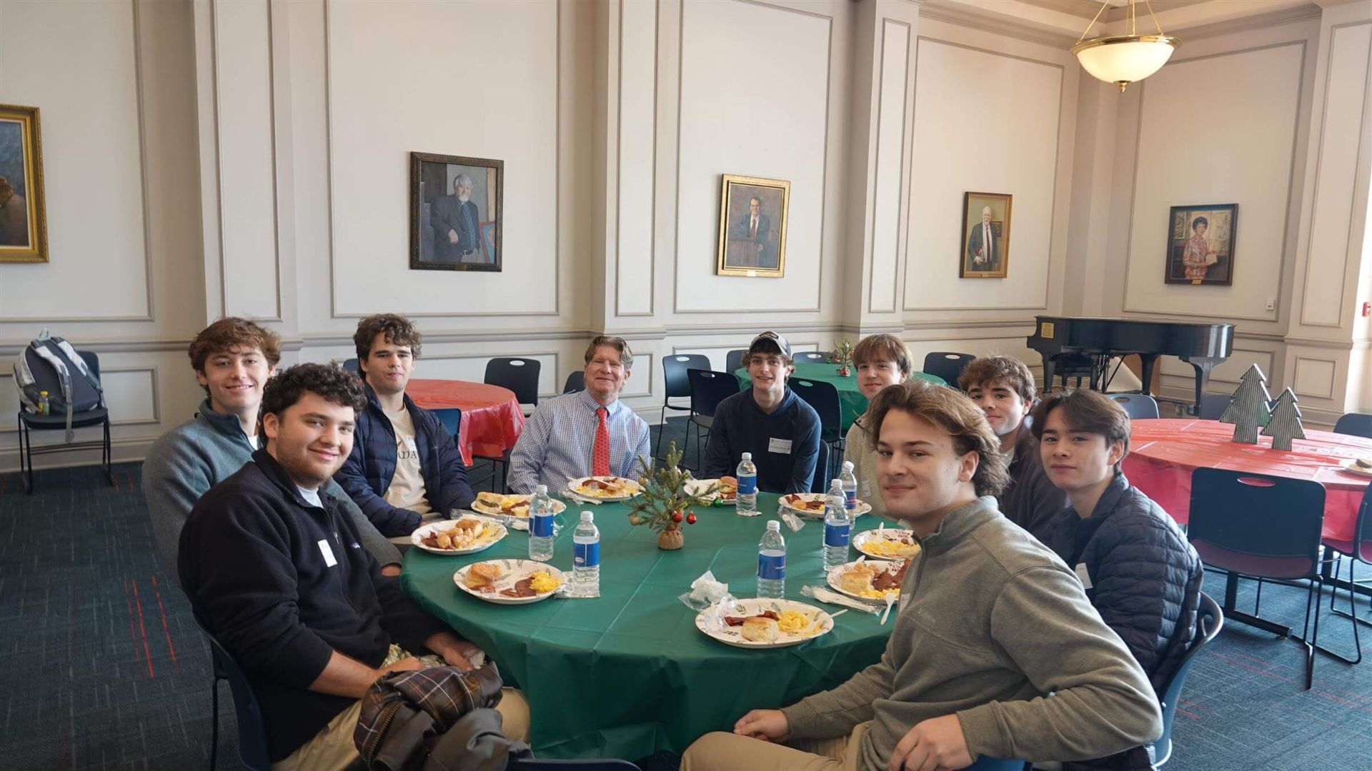 group of young men sitting at table